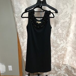 Black dress with jewel neckline.